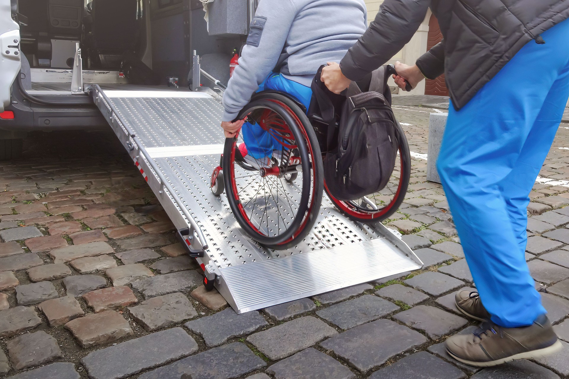 Wheelchair user on accessible car ramp